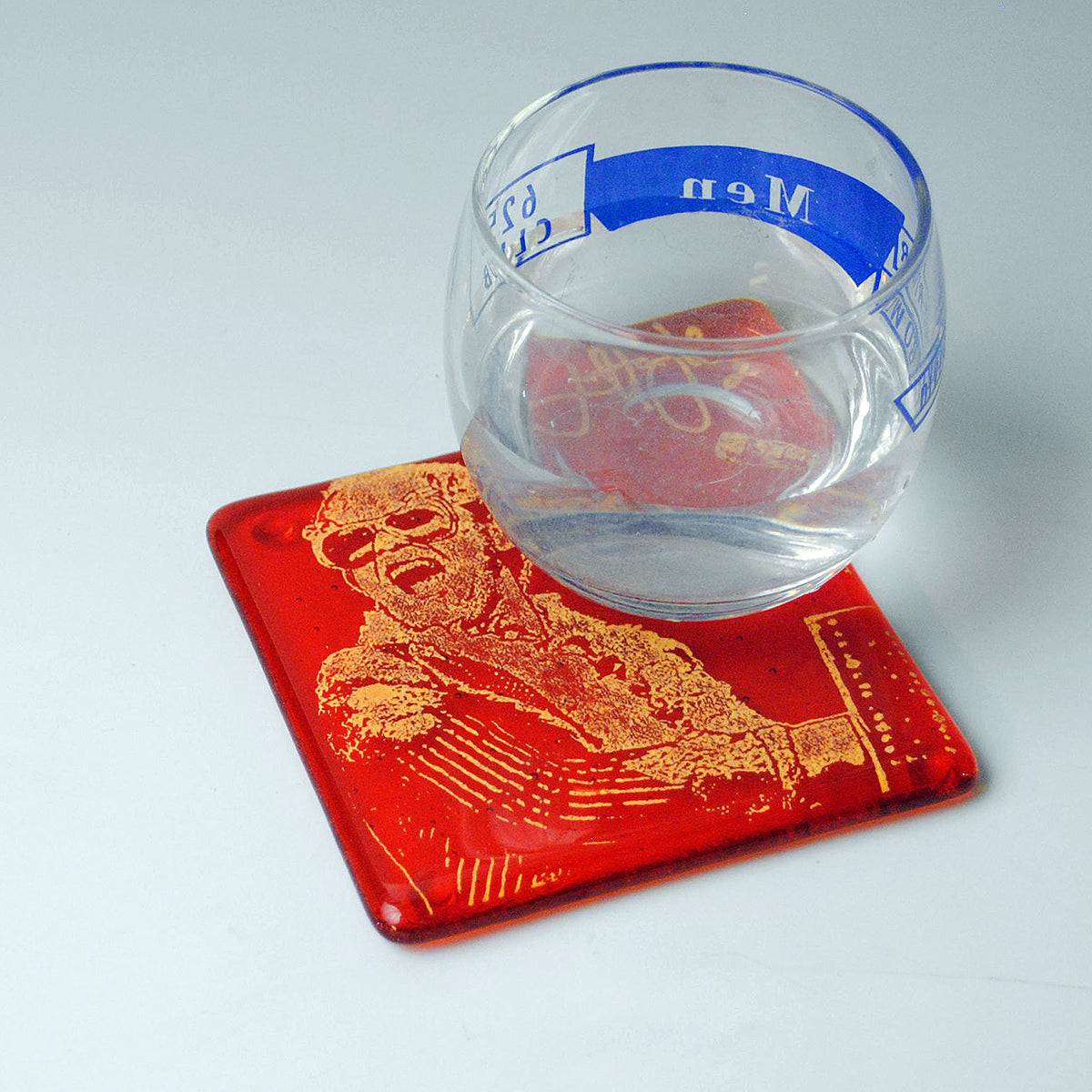 a glass of water and a red coaster