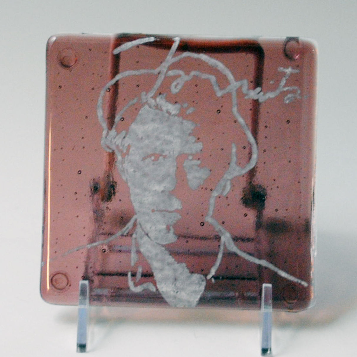 a piece of glass with a picture of a man on it