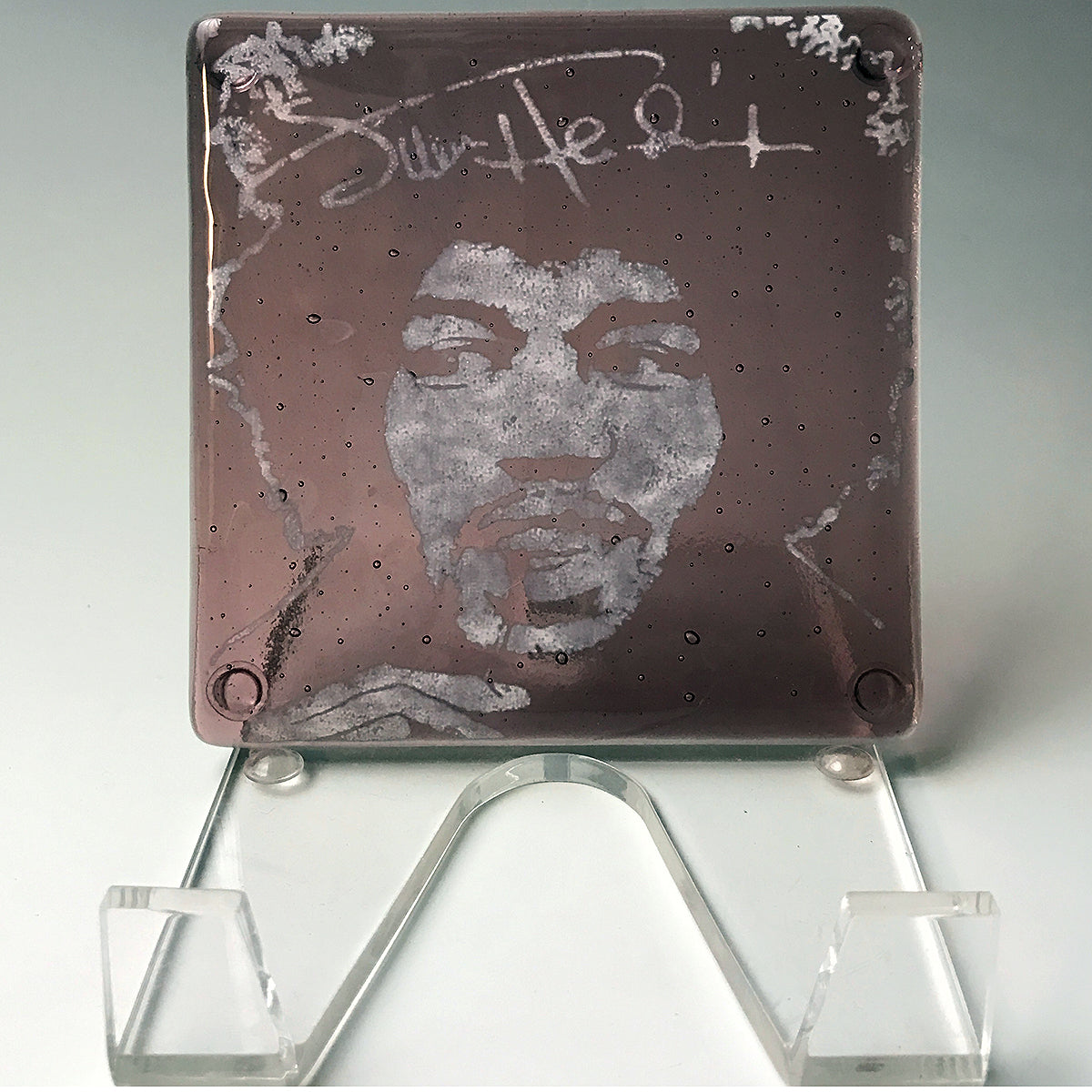 a picture of a man's face on a glass plaque