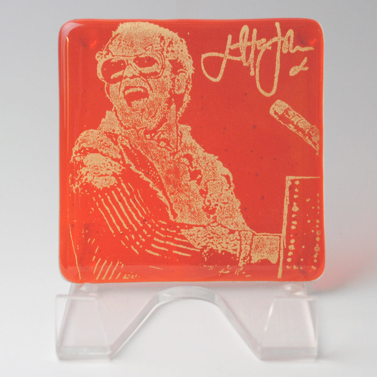 a plastic coaster with a picture of a man in glasses