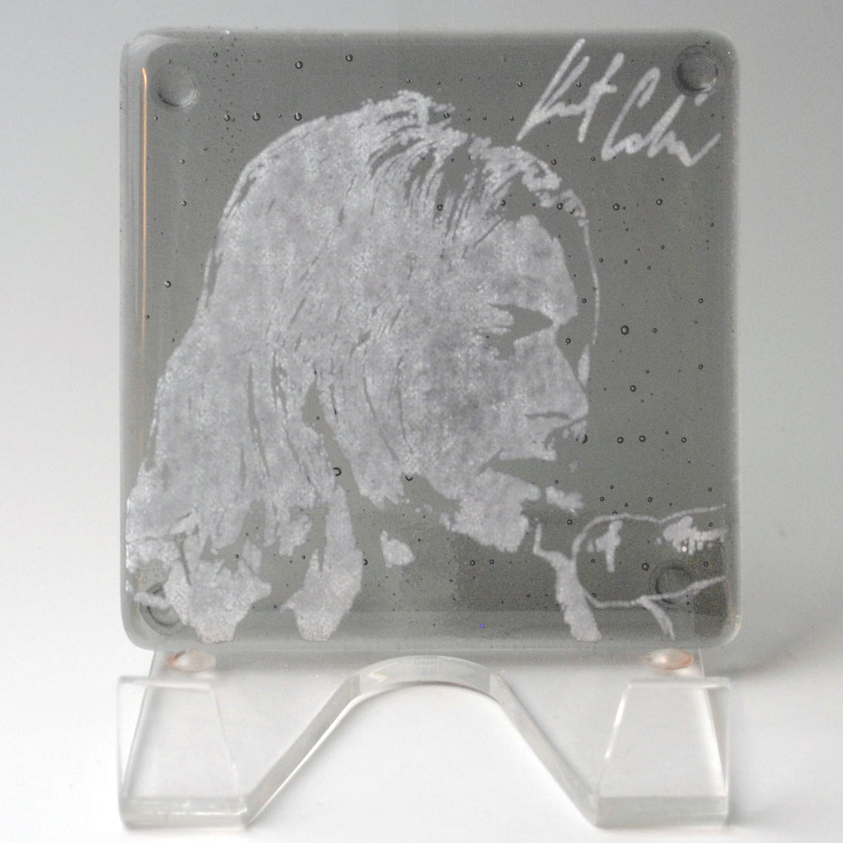 a glass block with a drawing of a man's face