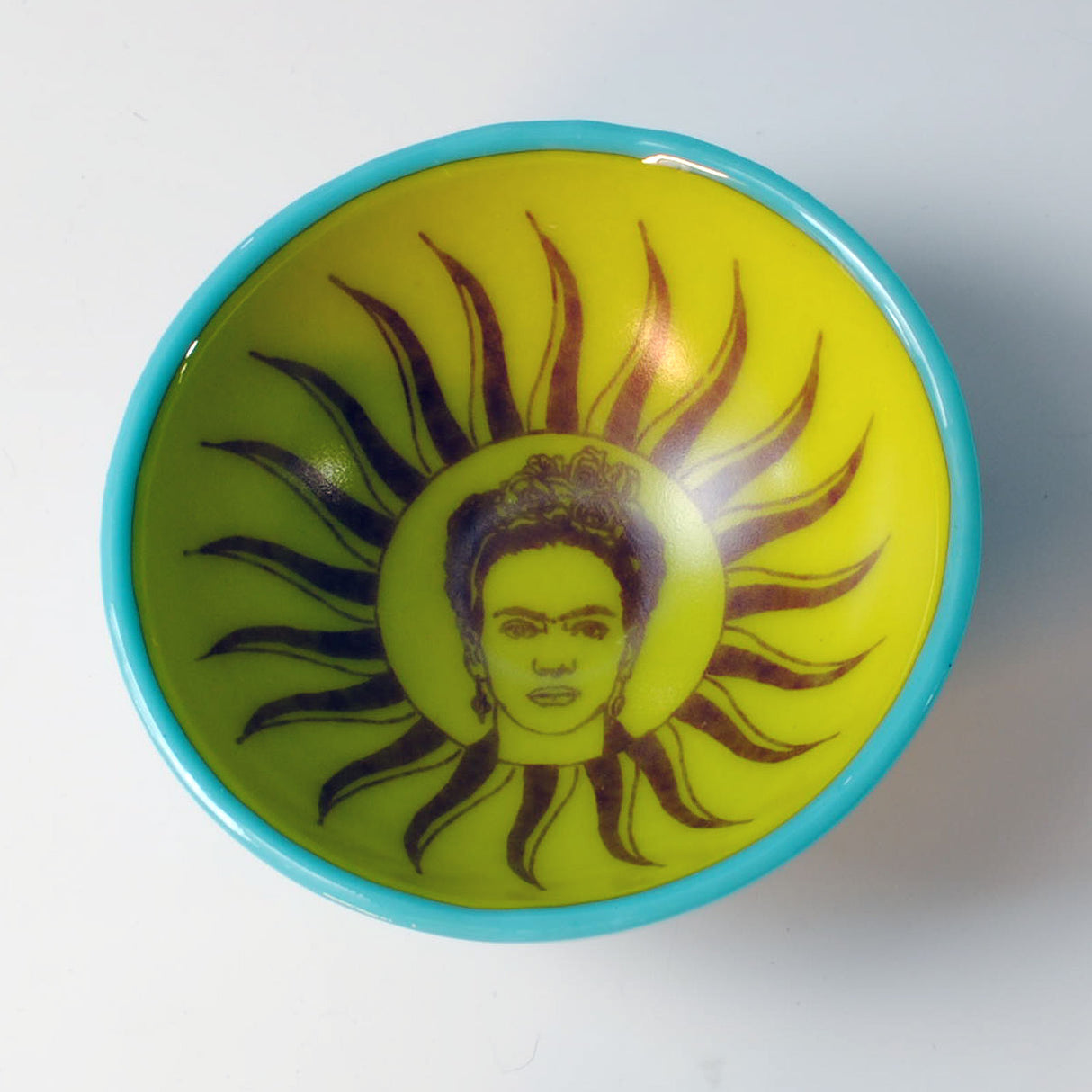 a yellow and blue bowl with a picture of a man on it
