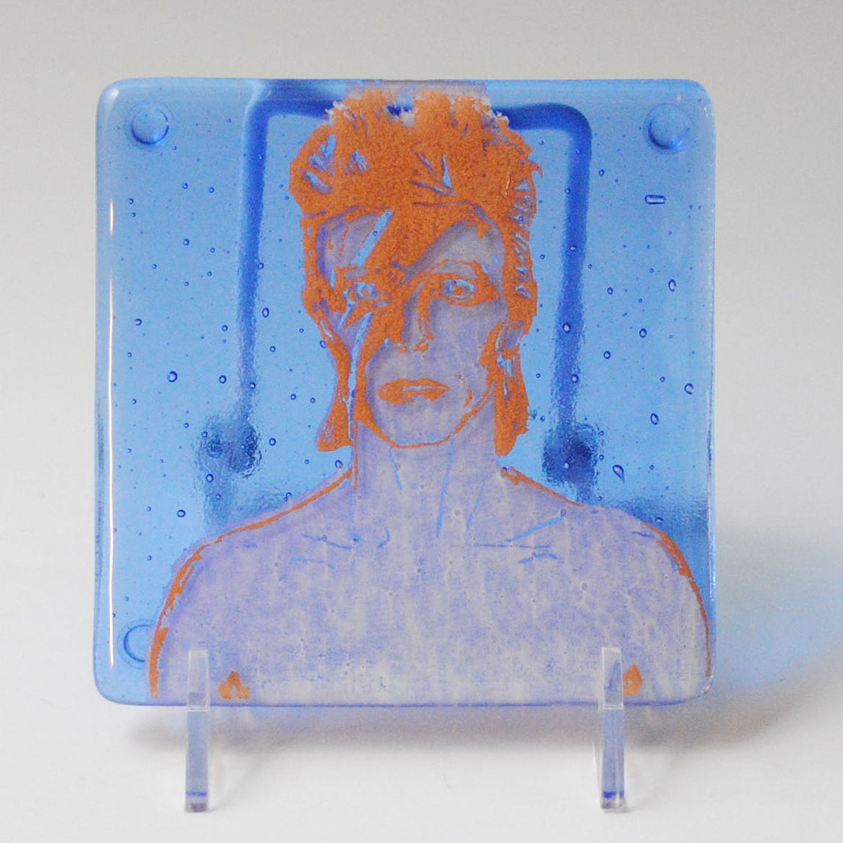 a glass picture of a man with orange hair