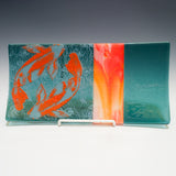 a glass plate with a fish design on it