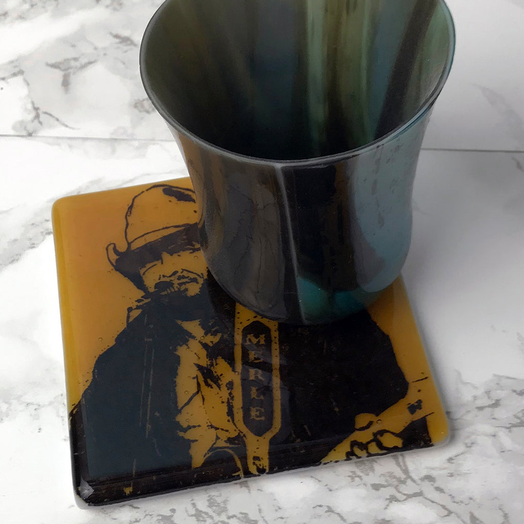 a metal cup sitting on top of a coaster
