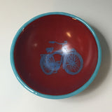 a red and blue bowl with a bicycle on it