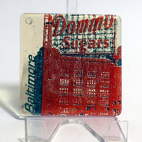 a picture of a red building on a clear stand