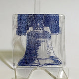 a glass block with a picture of a bell on it