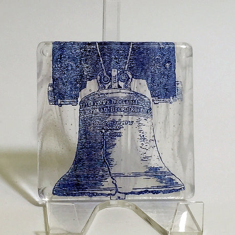 a glass block with a picture of a bell on it
