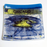 a blue and yellow plate with a picture of a car on it