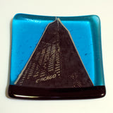 a blue plate with a picture of a building on it