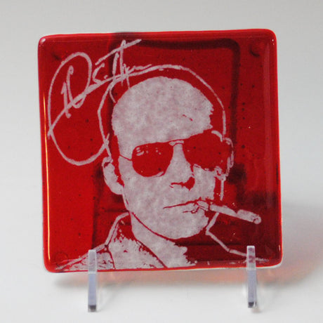 a glass plate with a picture of a man smoking a cigarette